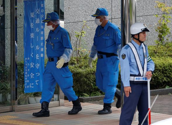 Police officers investigate at a facility for the disabled, where a deadly attack by a knife-wielding man took place, in Sagamihara, Kanagawa prefecture. REUTERS/Issei Kato