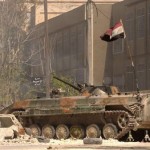 Syrian Army tank bearing a Syrian national flag is seen in Sheikh Maksoud, Aleppo