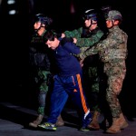 Drug lord Joaquin “El Chapo” Guzman is escorted by soldiers during a presentation in Mexico City
